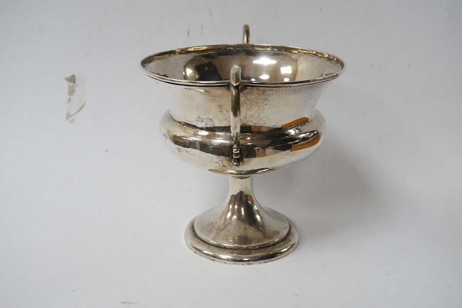 A white metal two handled pedestal trophy cup, stamped 'Barton silver', engraved with the letter S, height 16.3cm, 12.3oz. Condition - poor